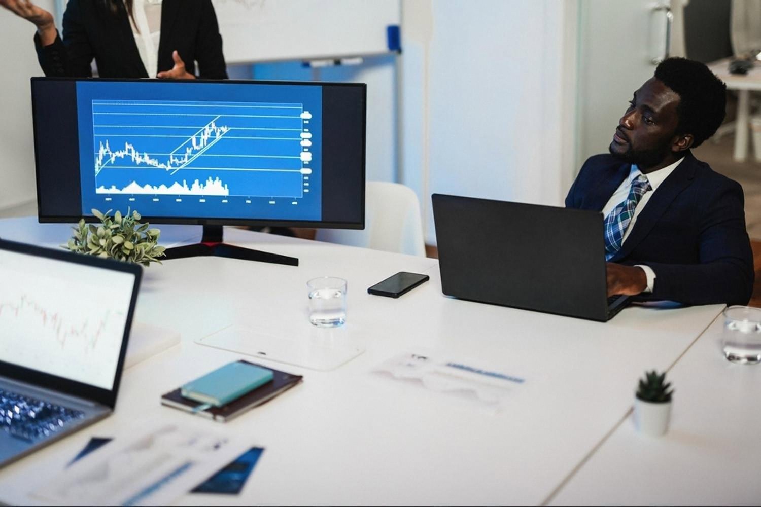 Manager in a UAE boardroom reviewing risk trend data on a large monitor